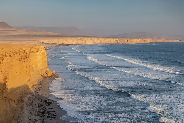 a cliffed coast with surf